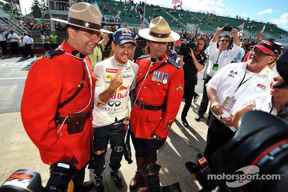 Race winner Sebastian Vettel, Red Bull Racing celebrates with two Canadian Mounted Police