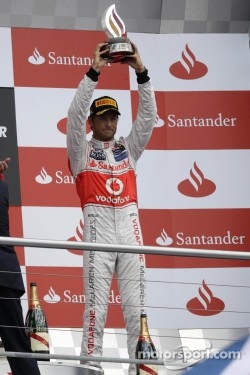 Jenson Button, McLaren celebrates his third position on the podium