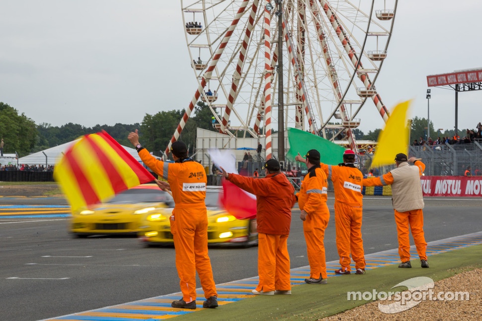 Corner workers celebrate and congratulate the drivers who completed the race