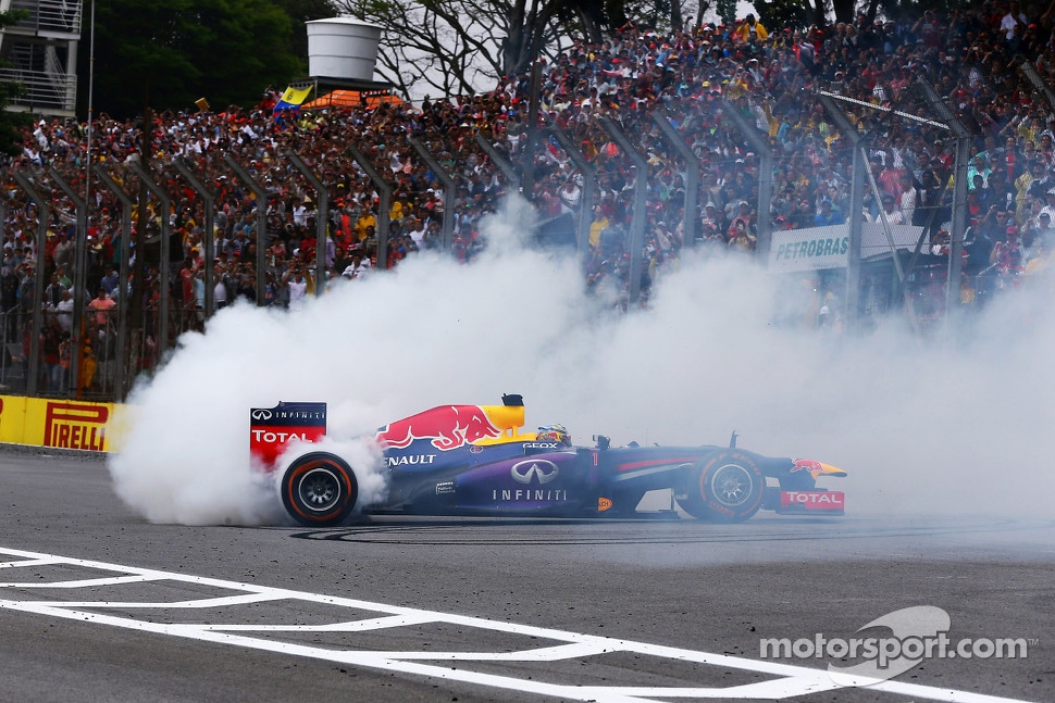 Race winner Sebastian Vettel, Red Bull Racing RB9 celebrates at the end of the race with donuts